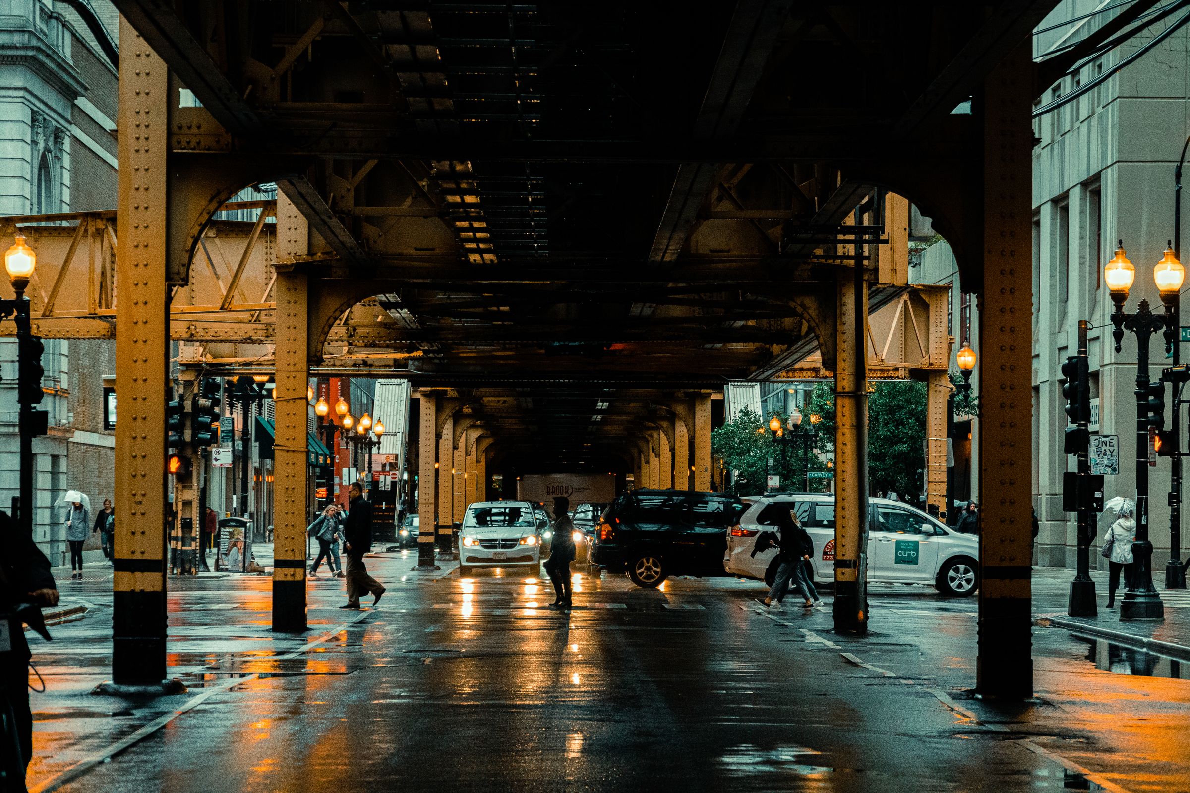 City street at night with wet pavement and headlights